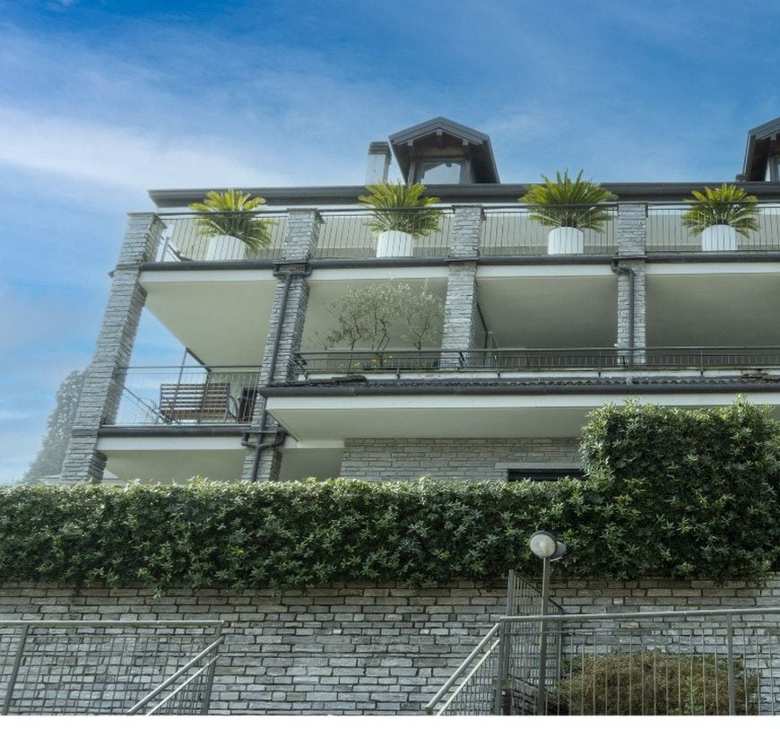 La palazzina in pietra vista dal giardino, con i balconi affacciati sul verde